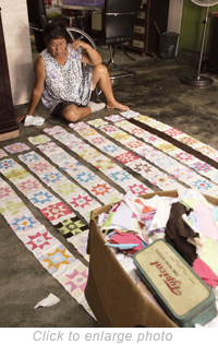 Mei Jing has been working into late night, sewing quilts out of colorful squares of cloth to be sold at charity bazaars.